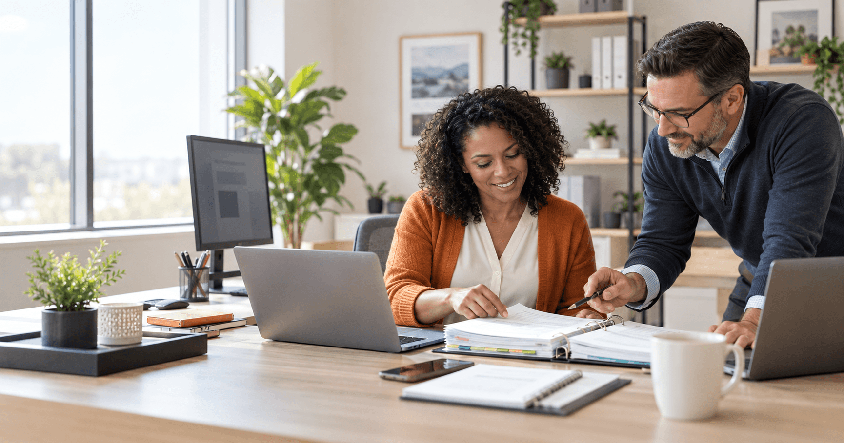 Two tax professionals coordinating a browser-based preparation workflow around a source-document binder